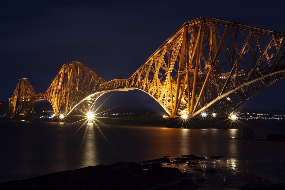 lighted bridge over water during night time