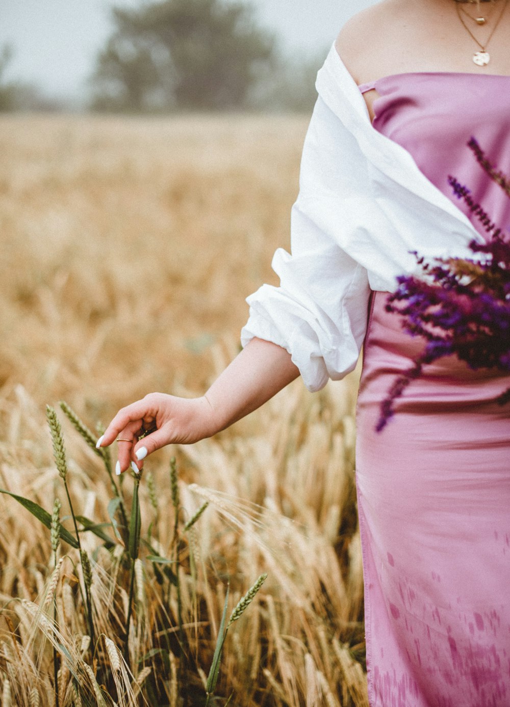 woman in pink dress holding white textile