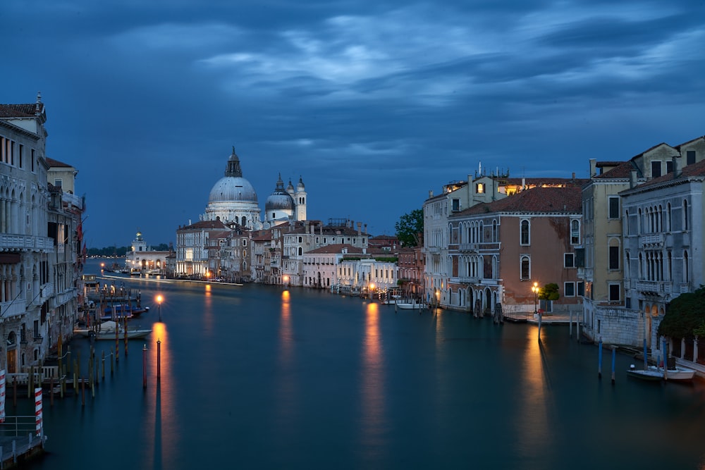 white and brown concrete building near body of water during night time