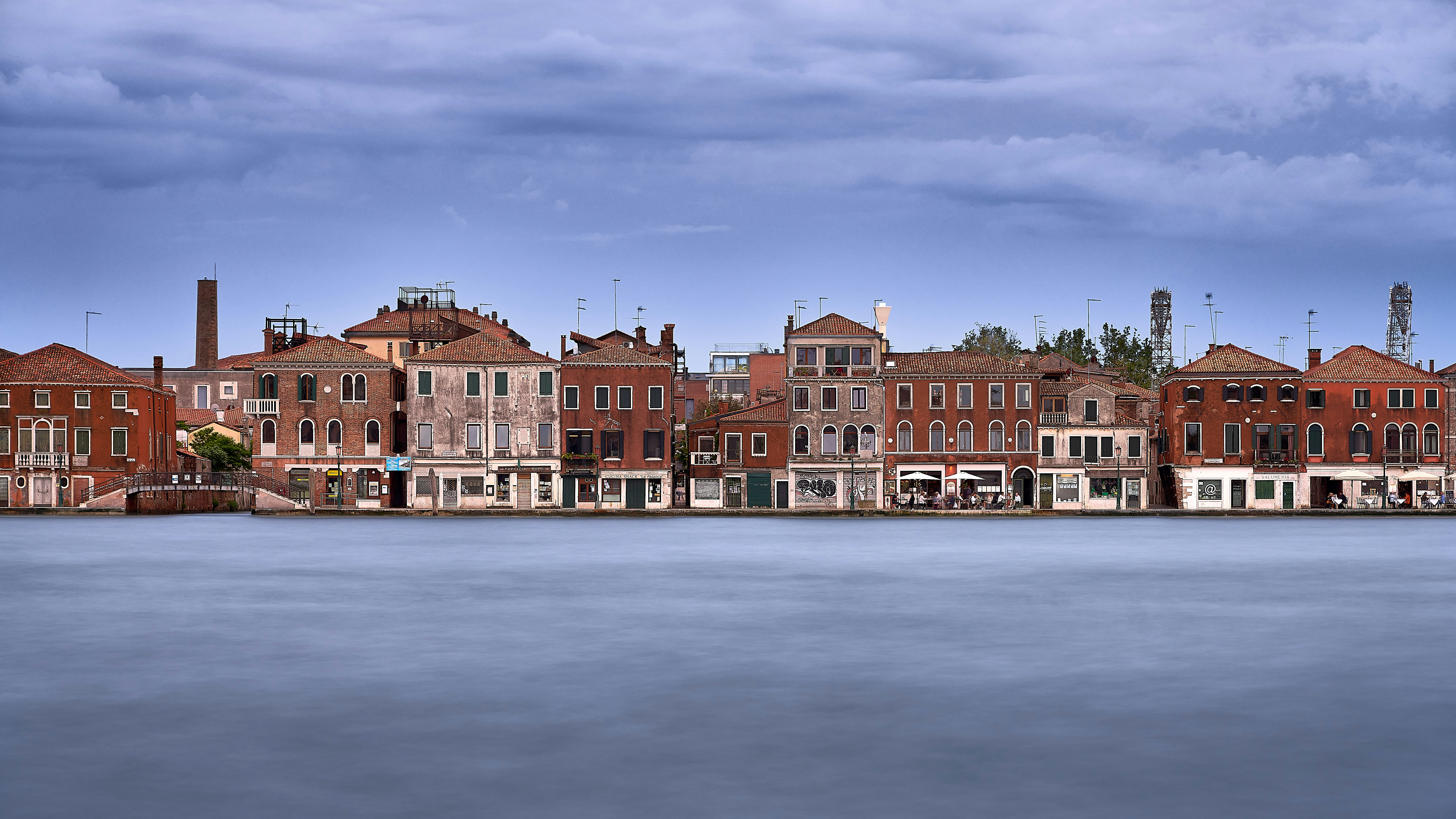 brown and white concrete building near body of water during daytime