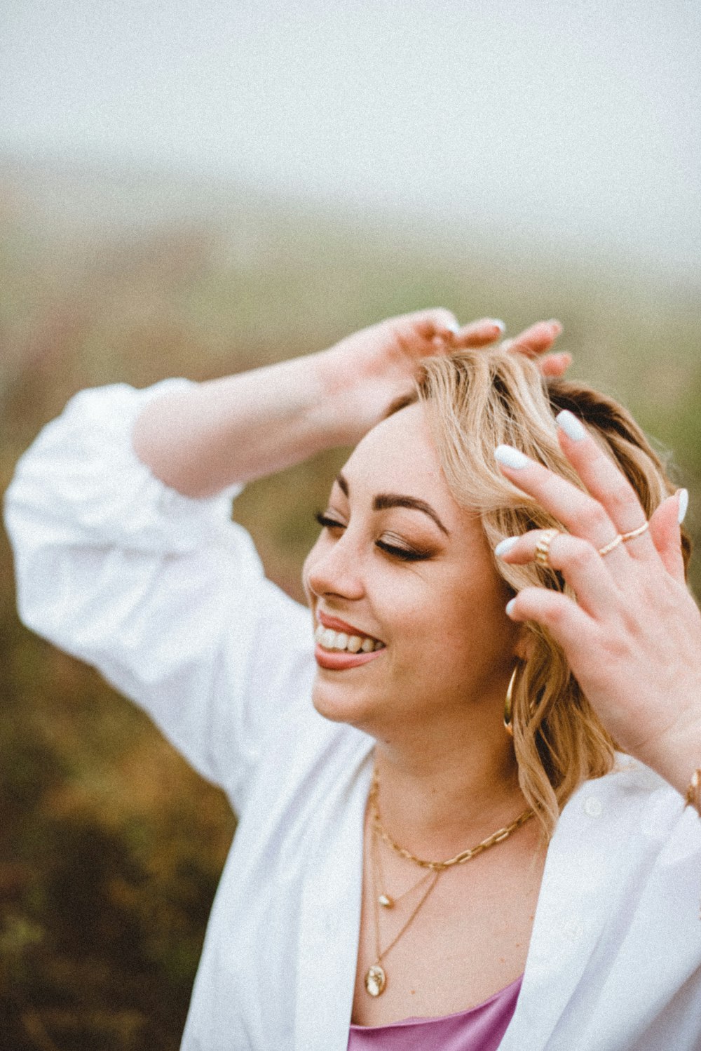 woman in white long sleeve shirt smiling