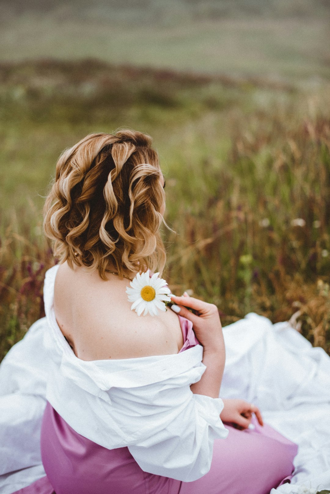 woman in white dress holding white flower