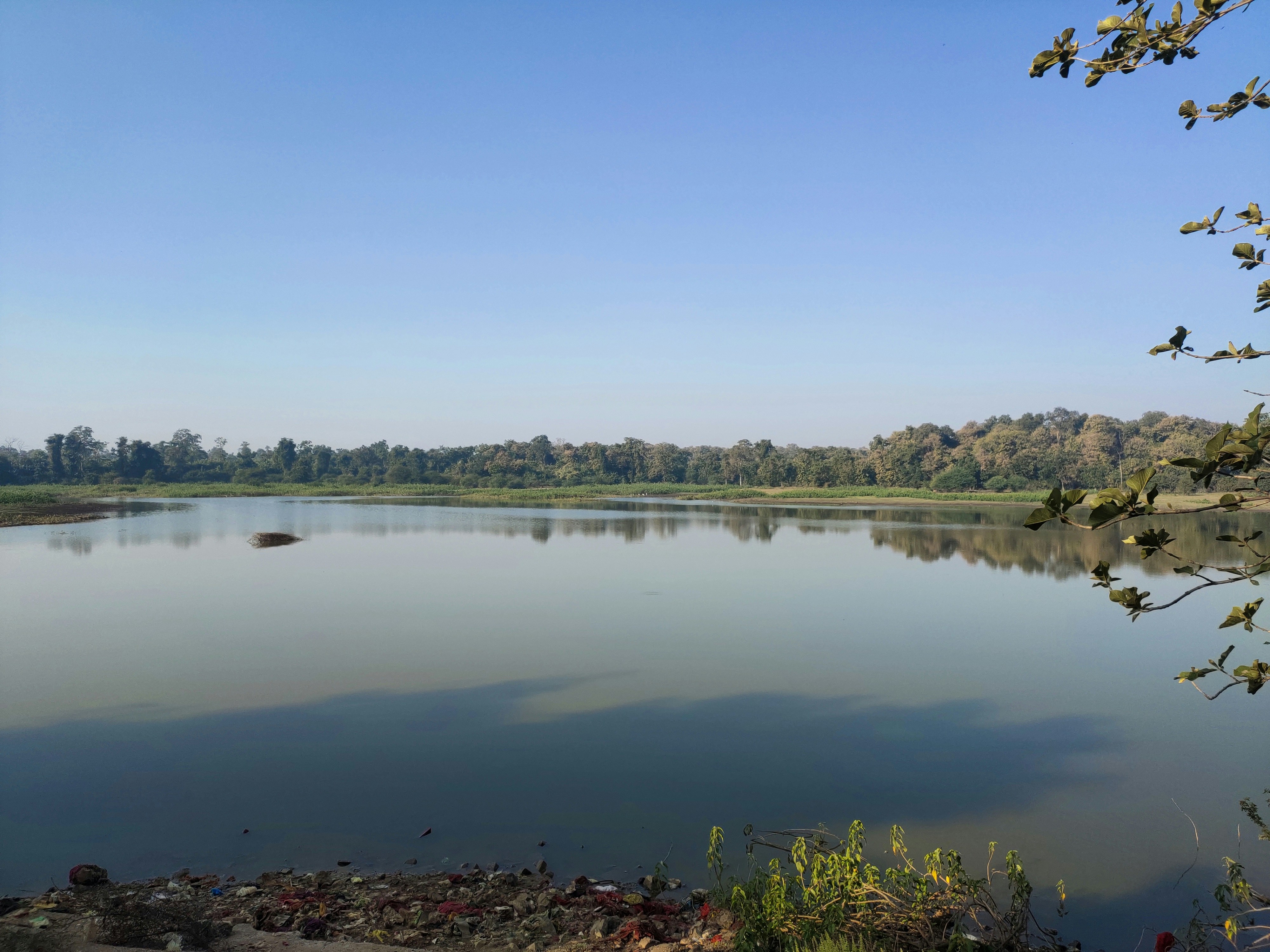 calm water under blue sky during daytime