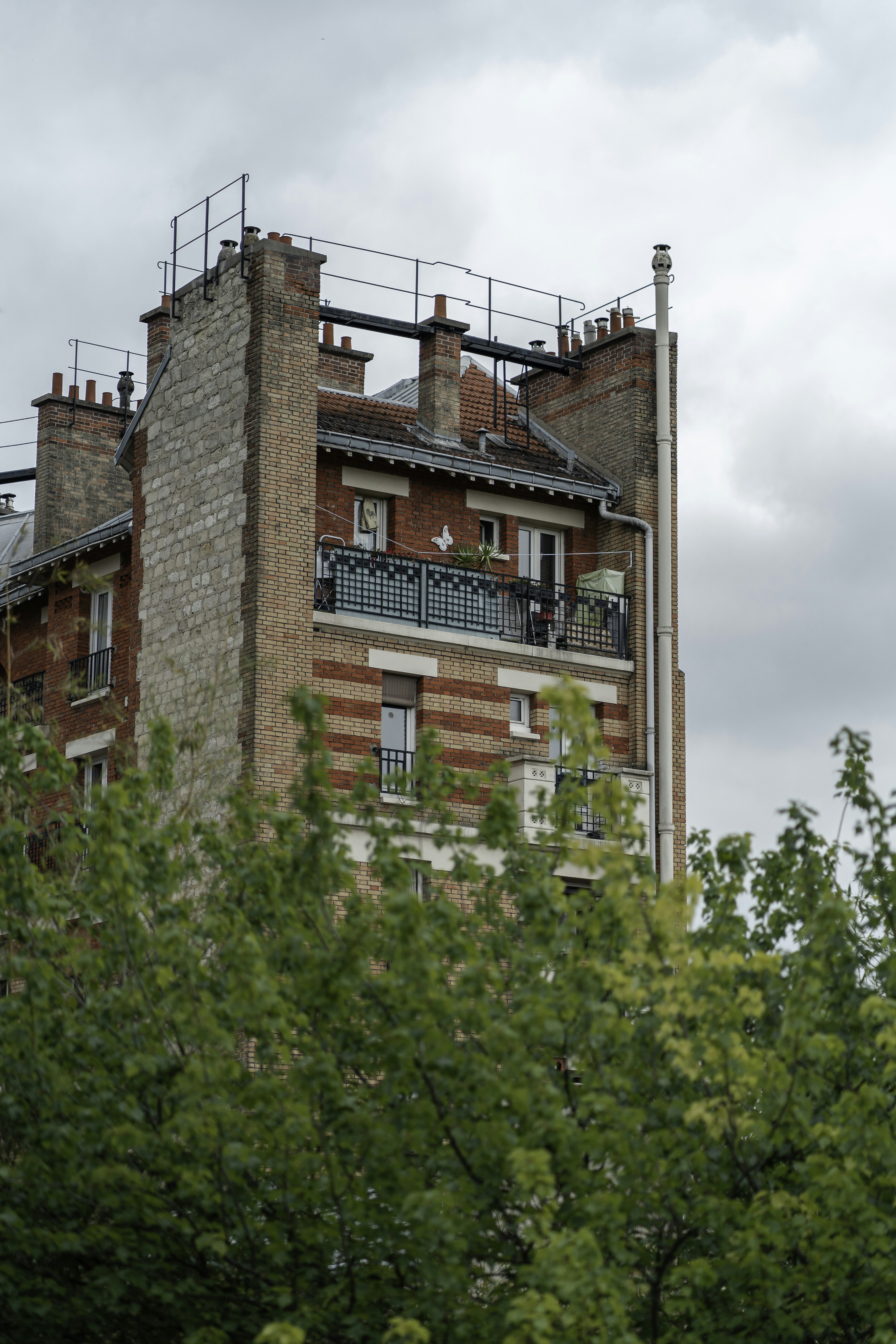 brown brick building near green trees during daytime