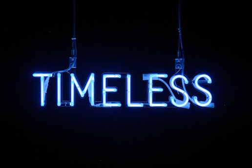 A glowing neon clock symbolizing unlimited, lifetime access to learning materials.