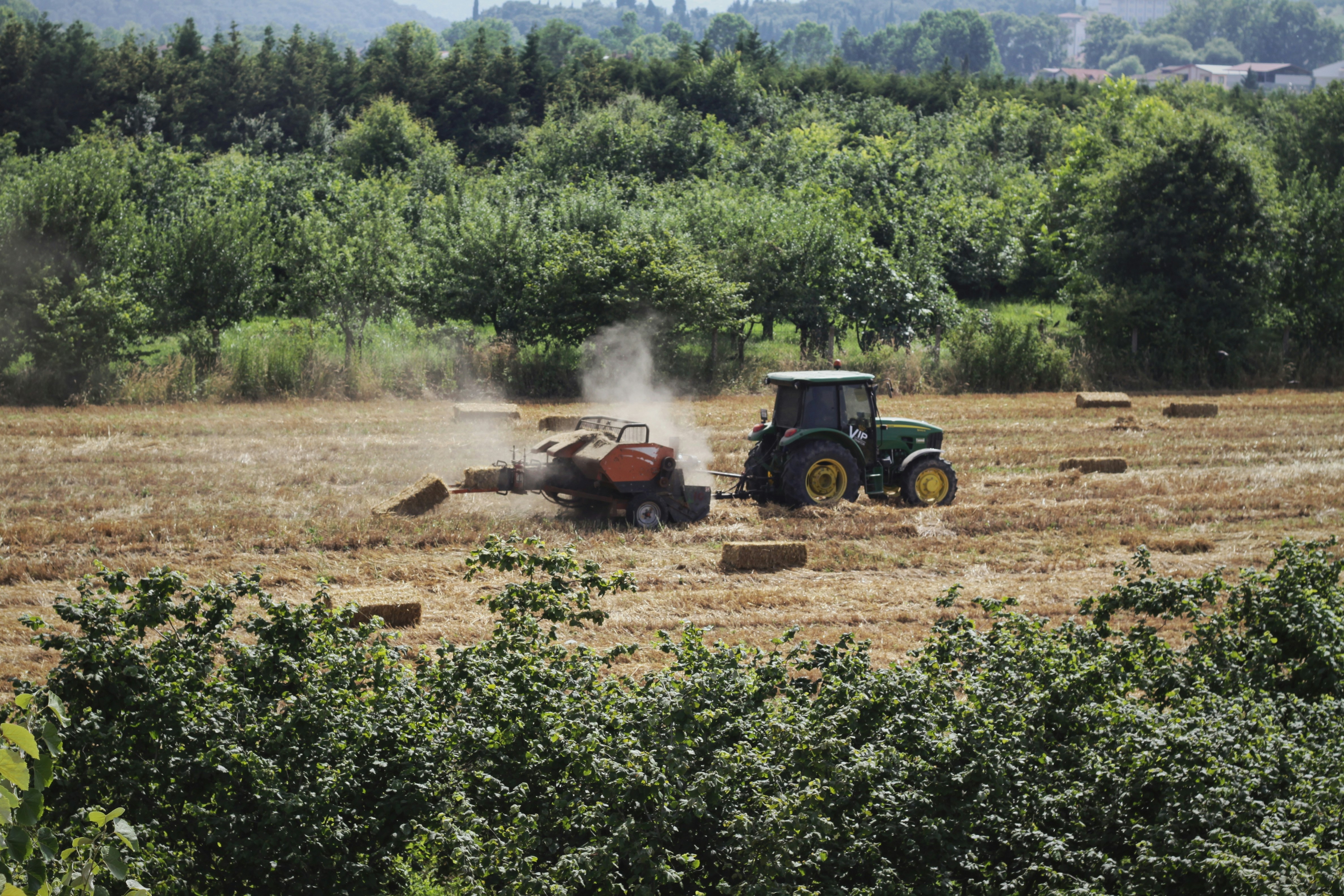 red tractor on brown field during daytime