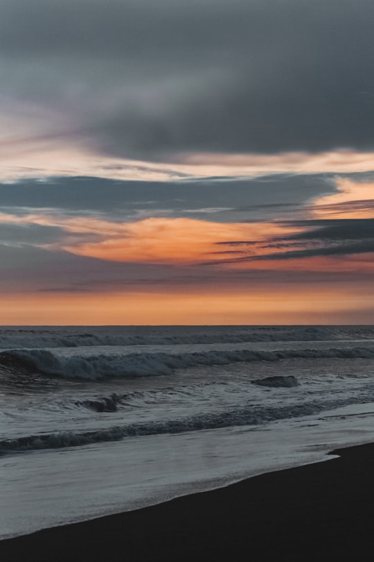 ocean waves crashing on shore during sunset in Sonsonate El Salvador