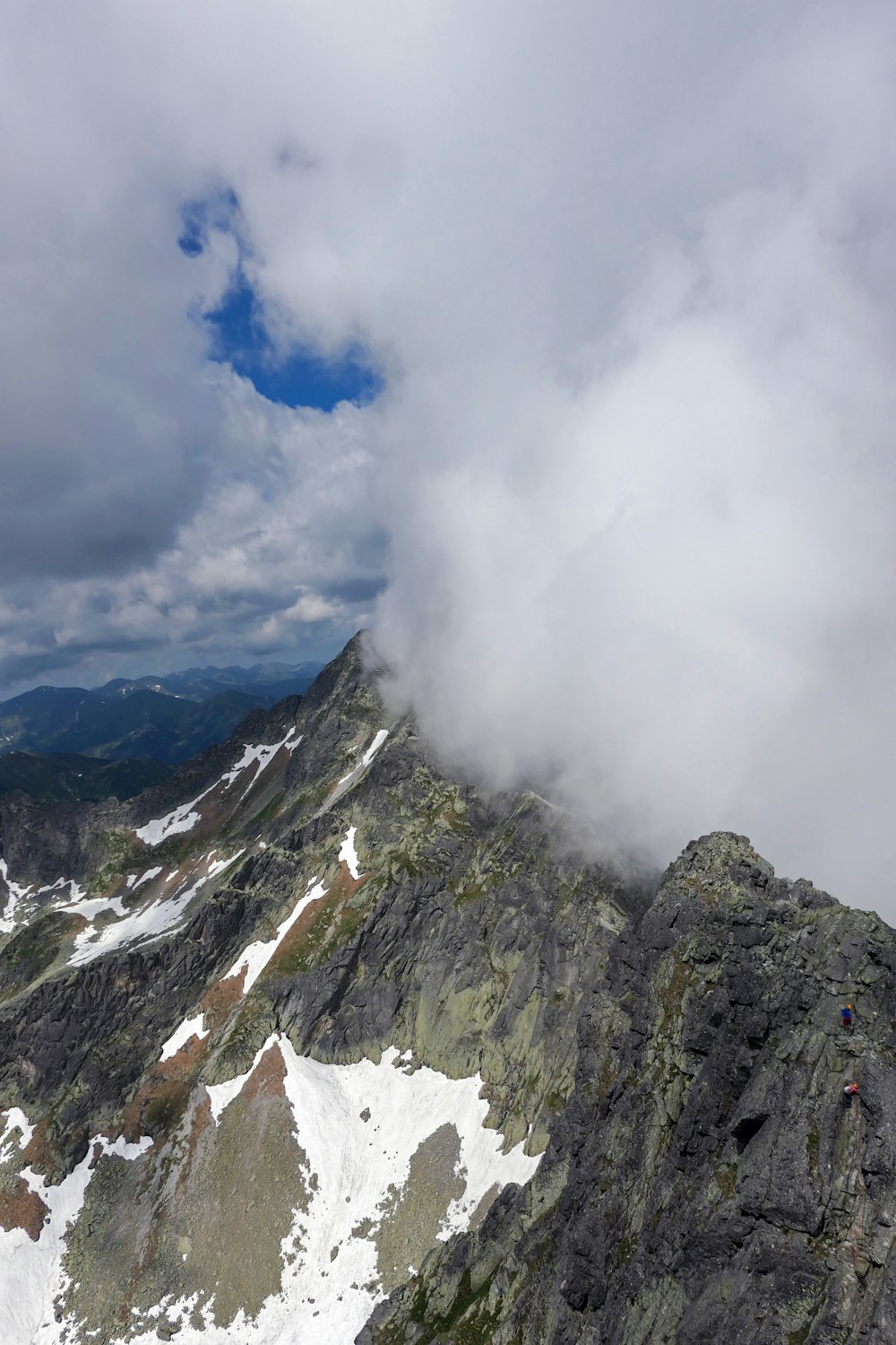 snow covered mountain under white clouds during daytime