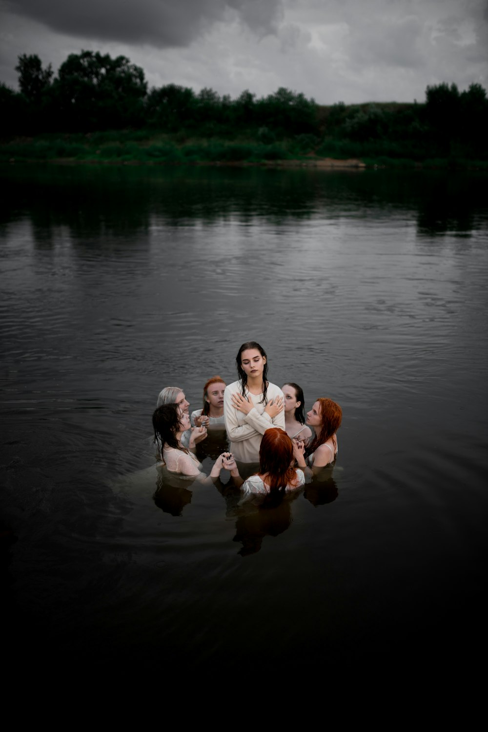 family of 4 sitting on water during daytime