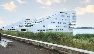 white concrete building near green grass field during daytime