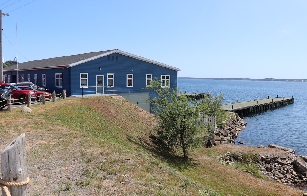 white and gray concrete house near body of water during daytime