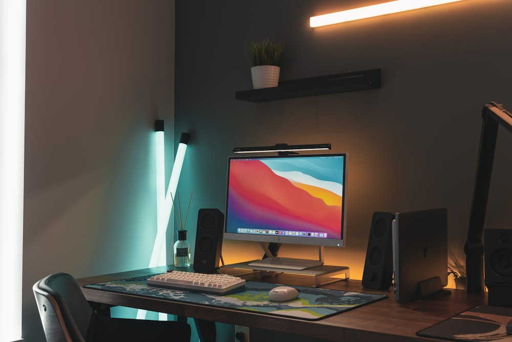 black flat screen computer monitor on brown wooden desk