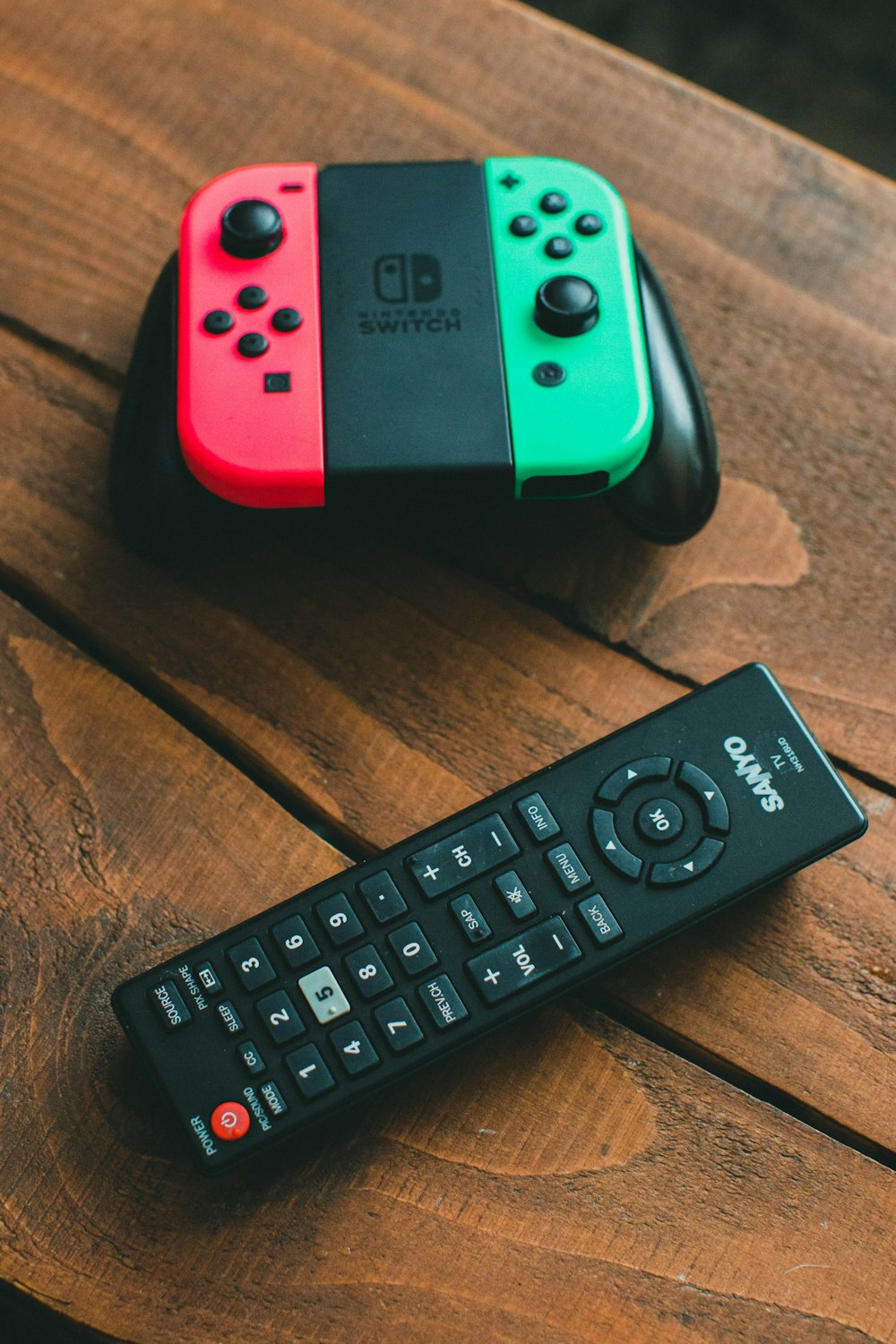 black remote control on brown wooden table