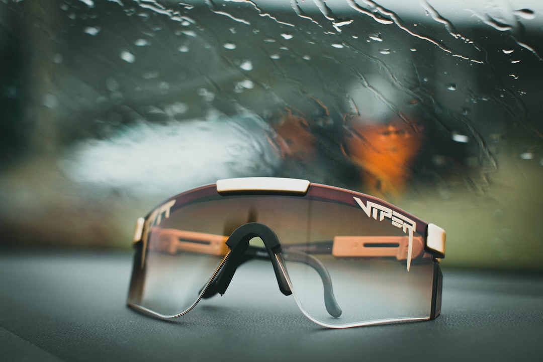 black framed sunglasses on glass table