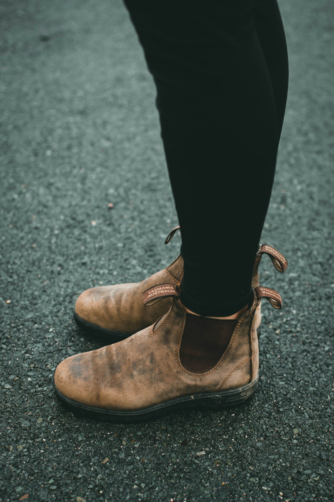 person wearing brown leather boots