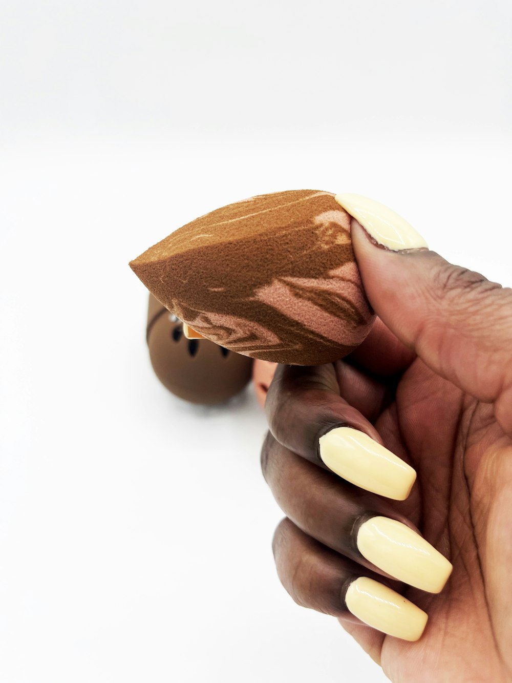 person holding brown wooden heart shaped ornament