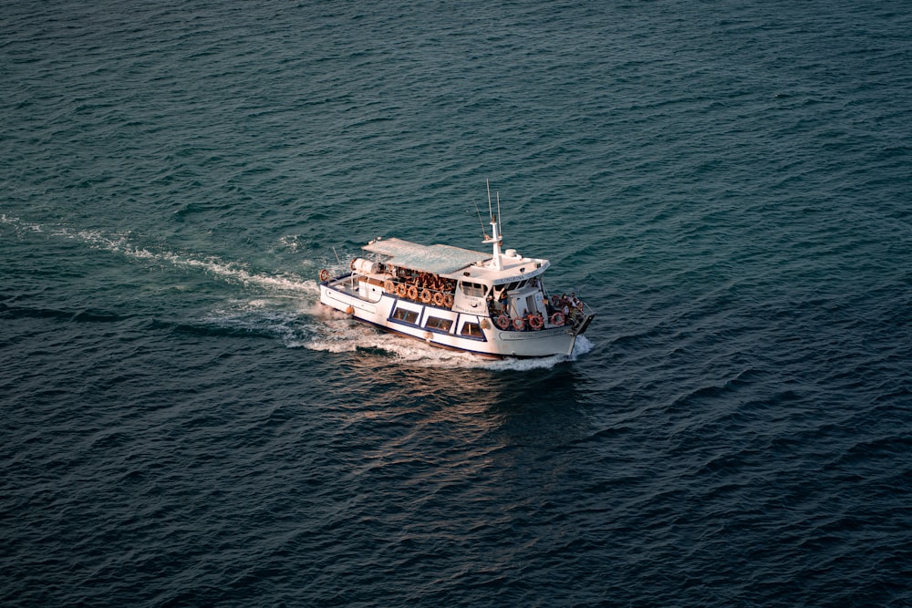 white and black boat on sea during daytime