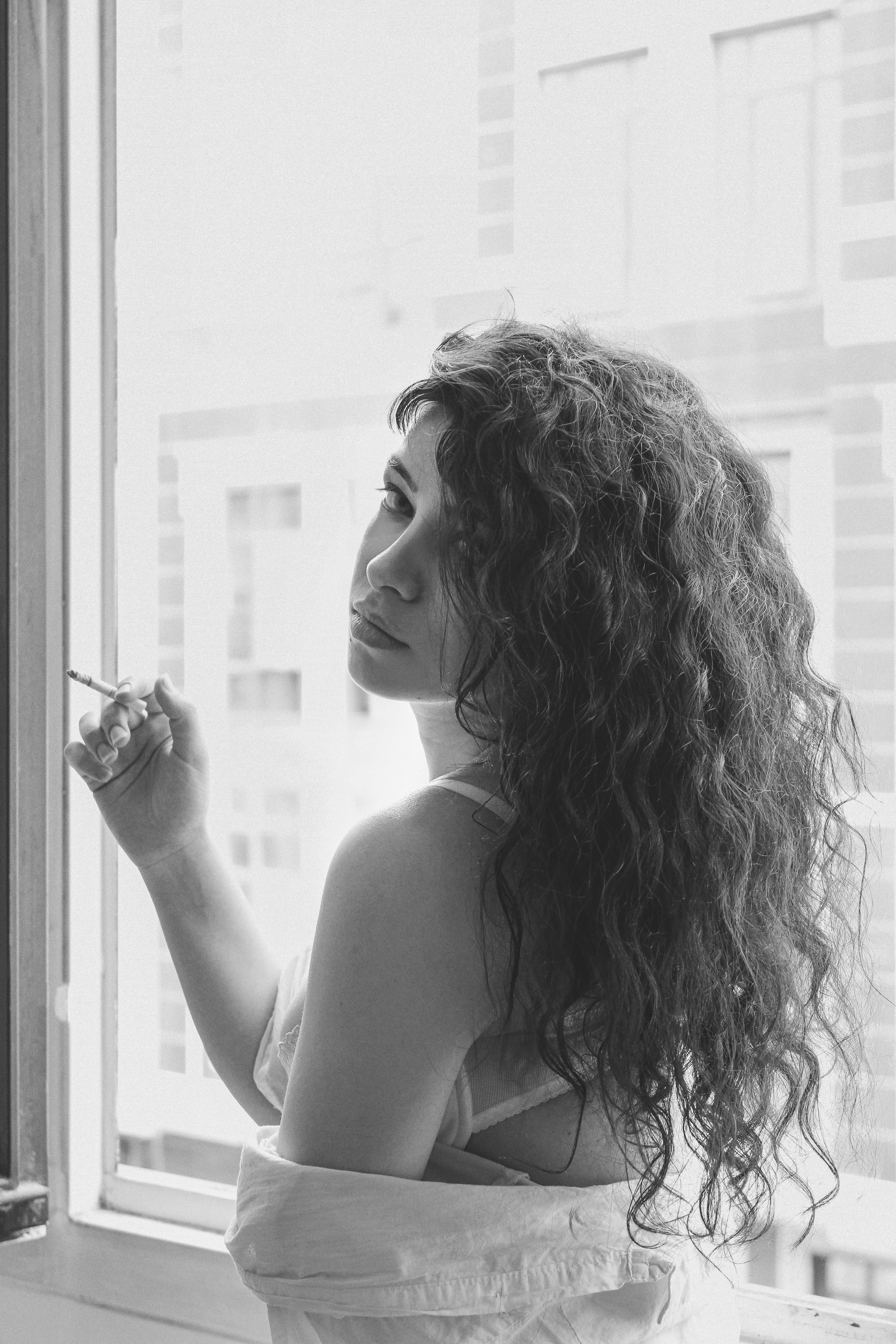 woman in tank top holding her hair