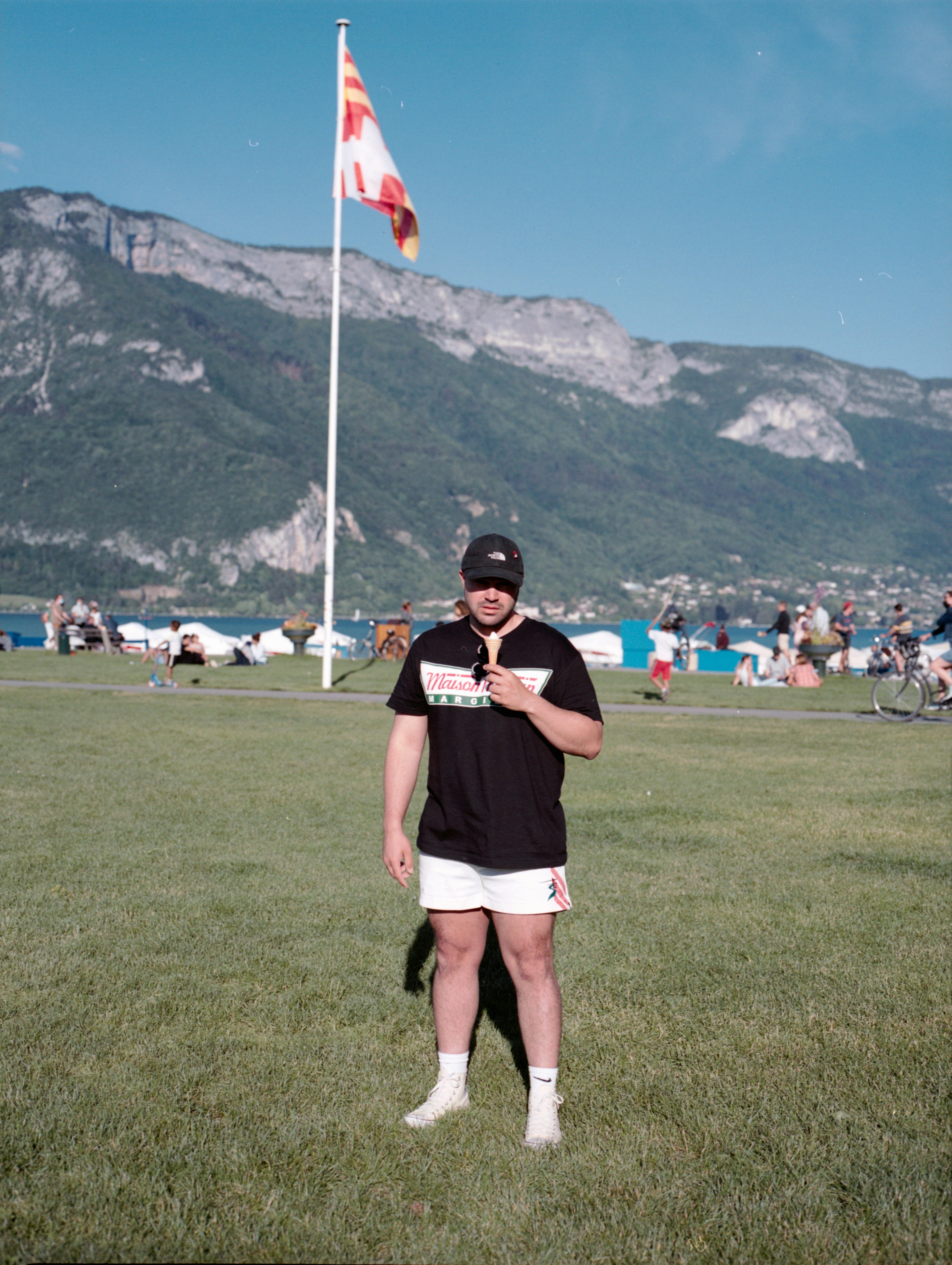 woman in black shirt and white shorts standing on green grass field during daytime