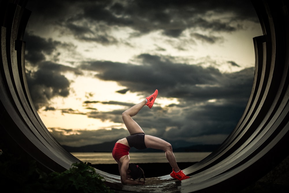 woman in black tank top and shorts doing yoga