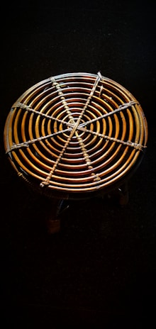 Artisan weaving traditional rattan crafts in a bright Lombok workshop.