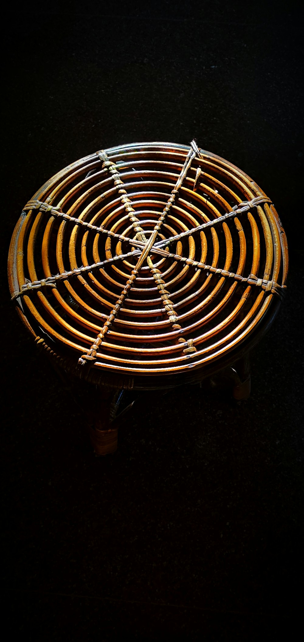 round yellow electric fan turned on in dark room