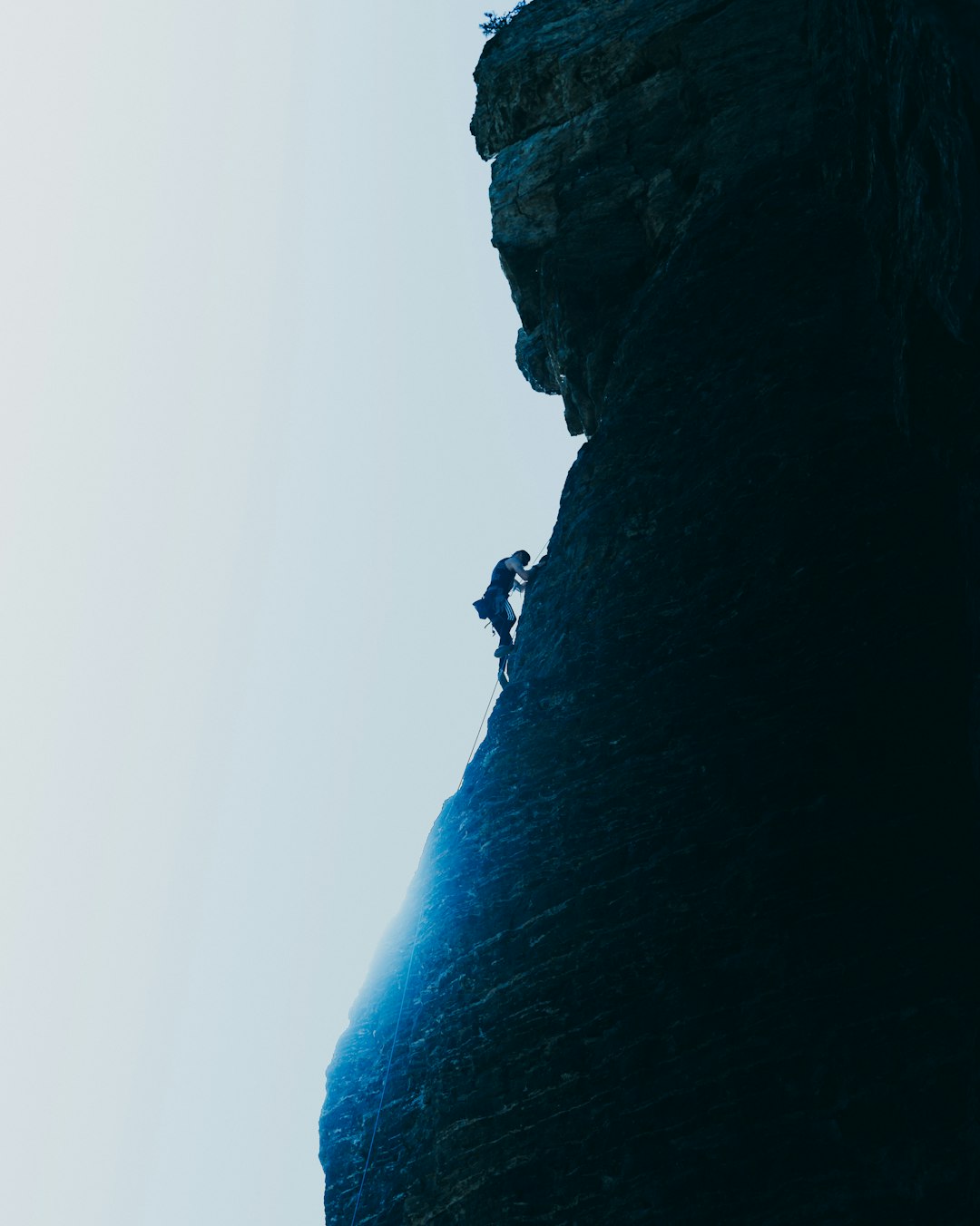 person standing on rock formation during daytime