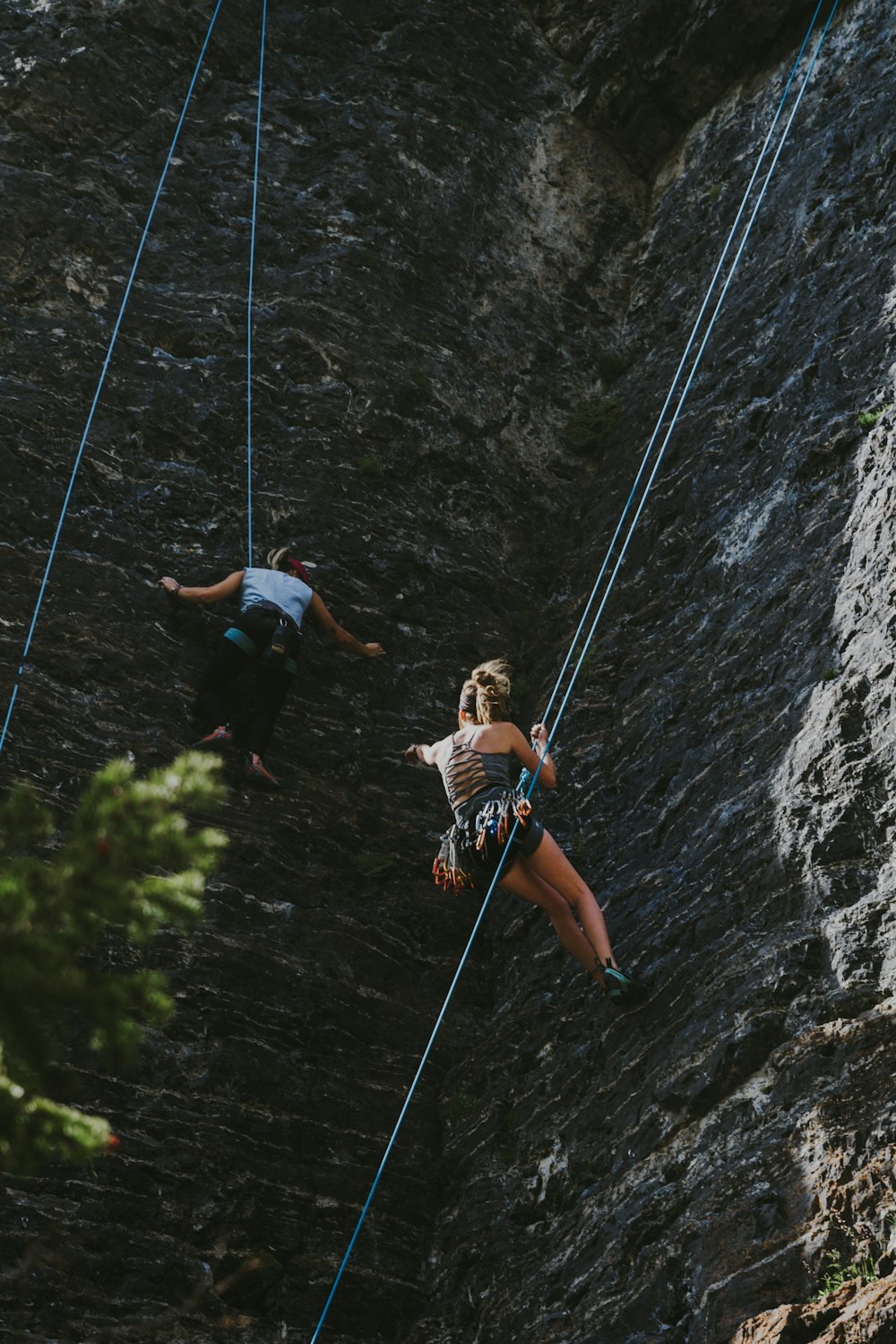 man in orange shirt climbing on rope