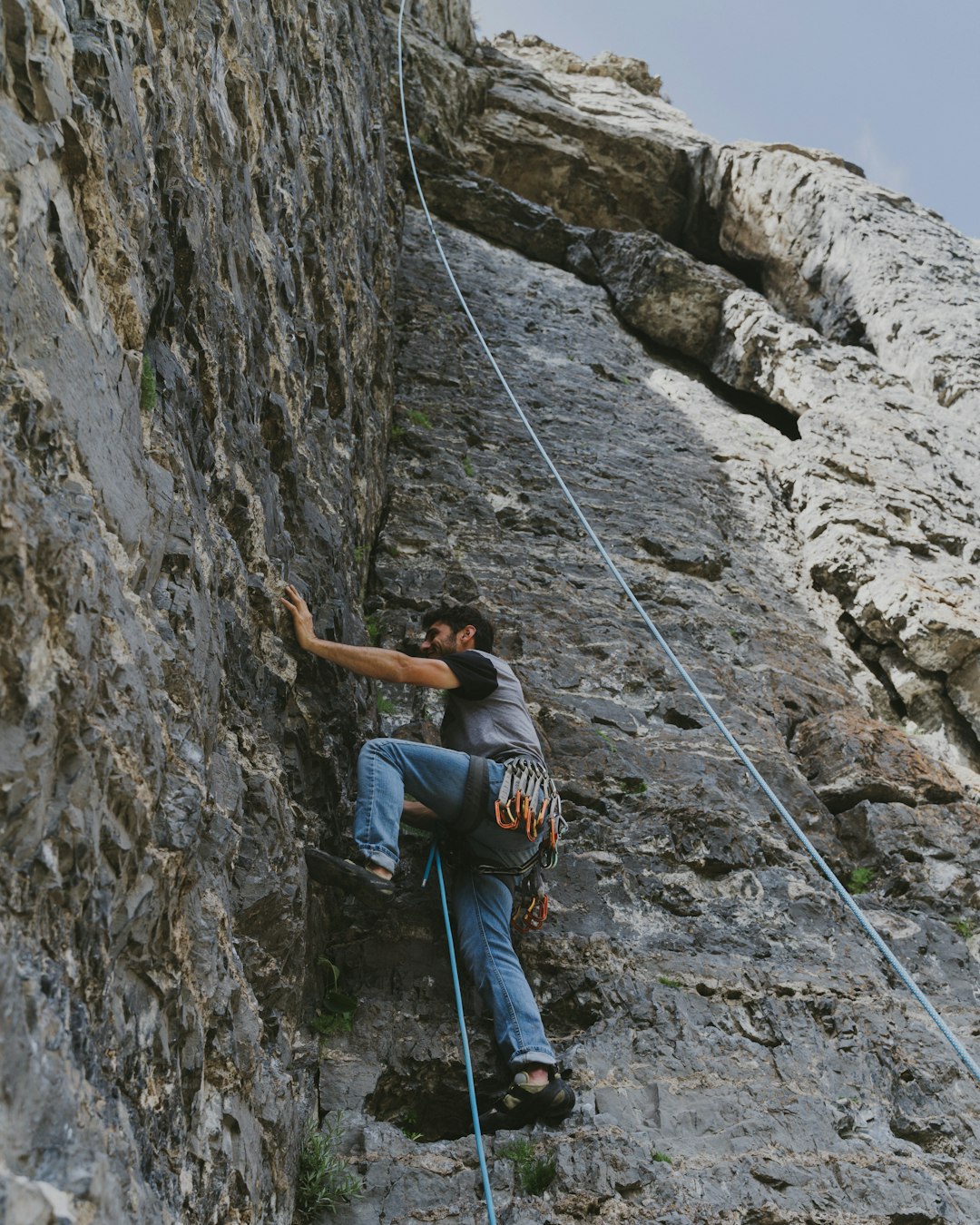man in grey t-shirt climbing on rock