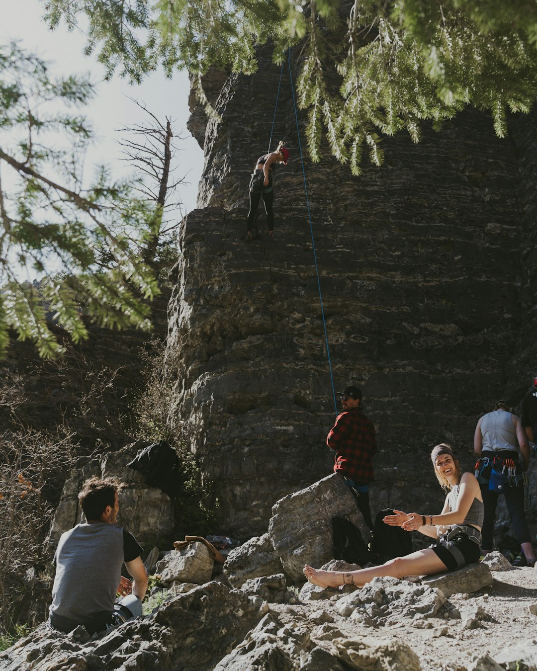 people climbing on rocky mountain during daytime