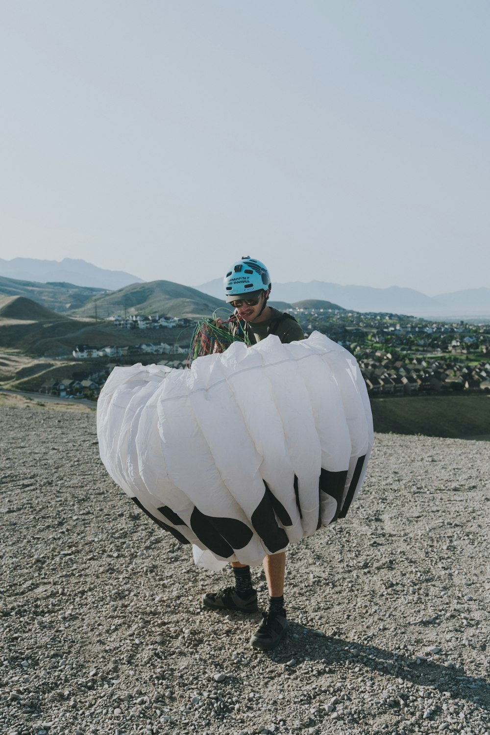 woman in white dress holding white balloons