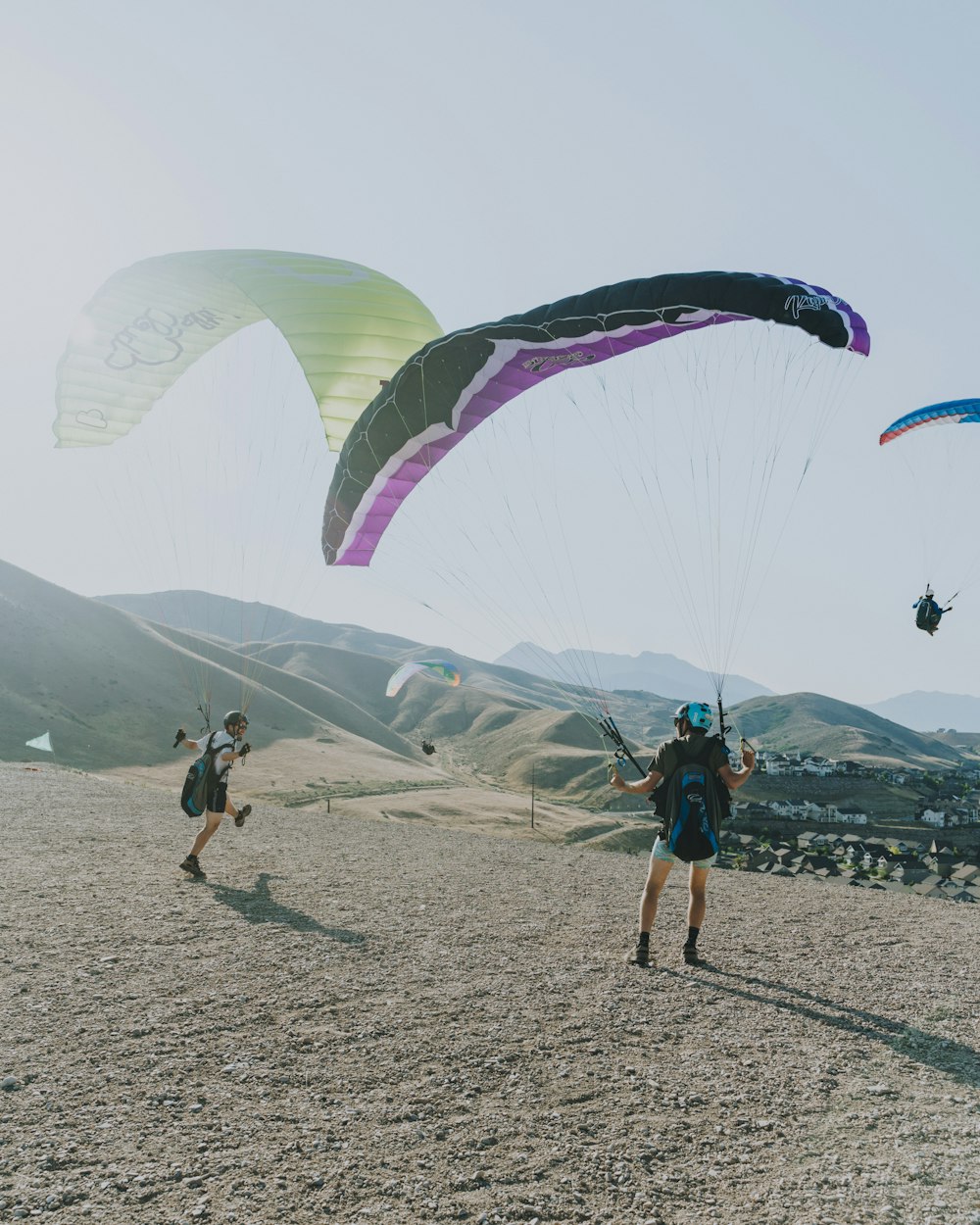 people on beach with parachute