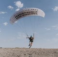 man in black shirt riding parachute during daytime