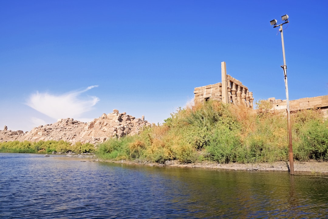 brown concrete building near body of water during daytime