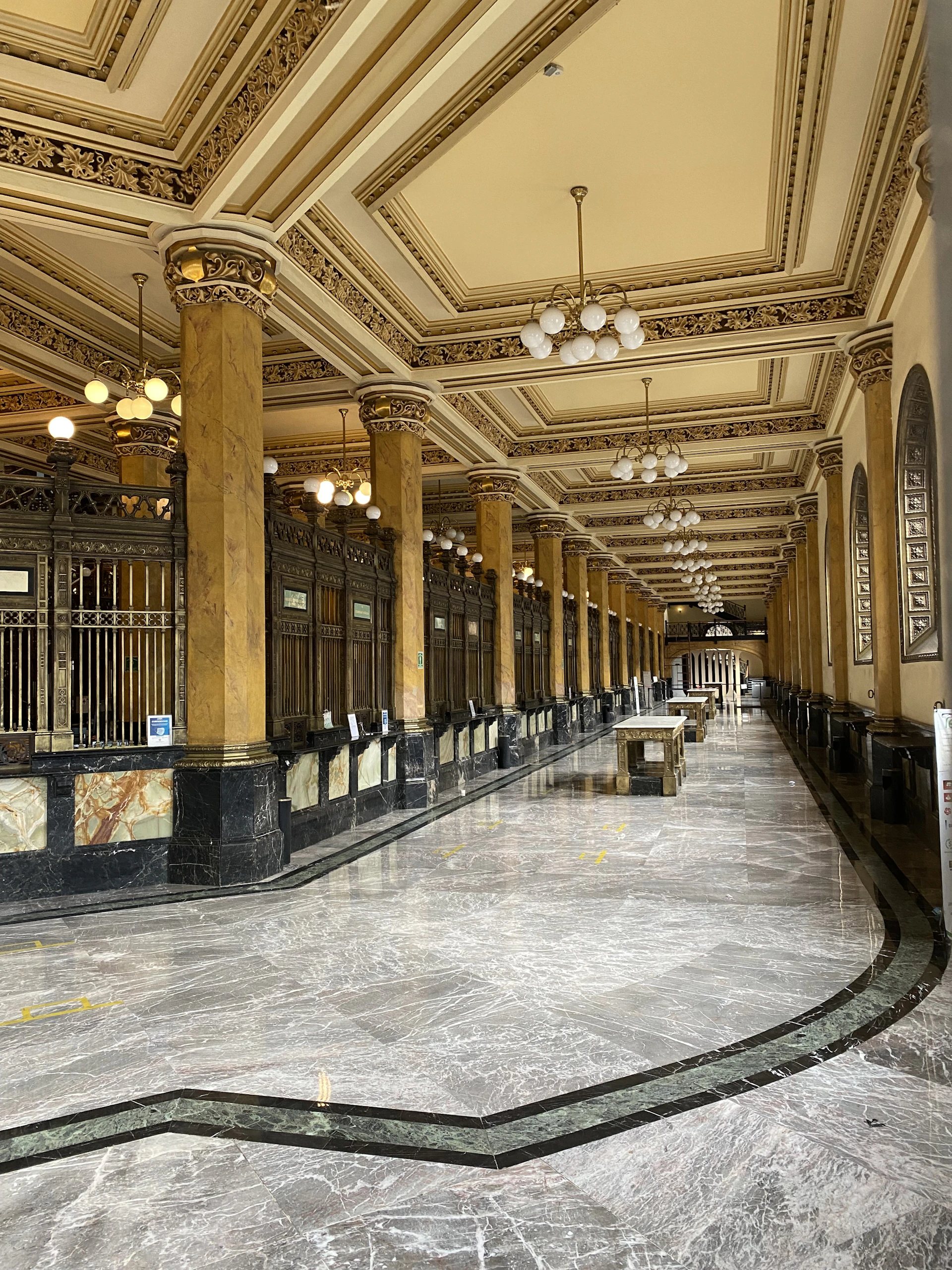 A grand hotel lobby with soaring ceilings, intricate architectural details, and a welcoming ambiance created by Unique Interiors.