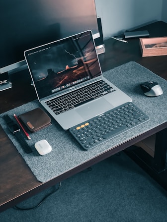 macbook pro on brown wooden table