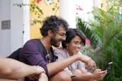 Smiling users interacting happily with a sleek Android app on their smartphones outdoors.