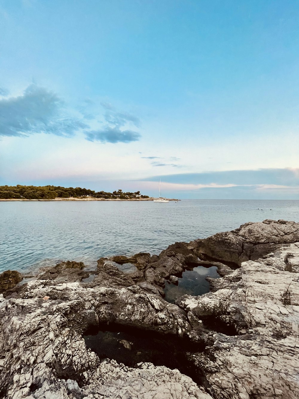 rocky shore under blue sky during daytime