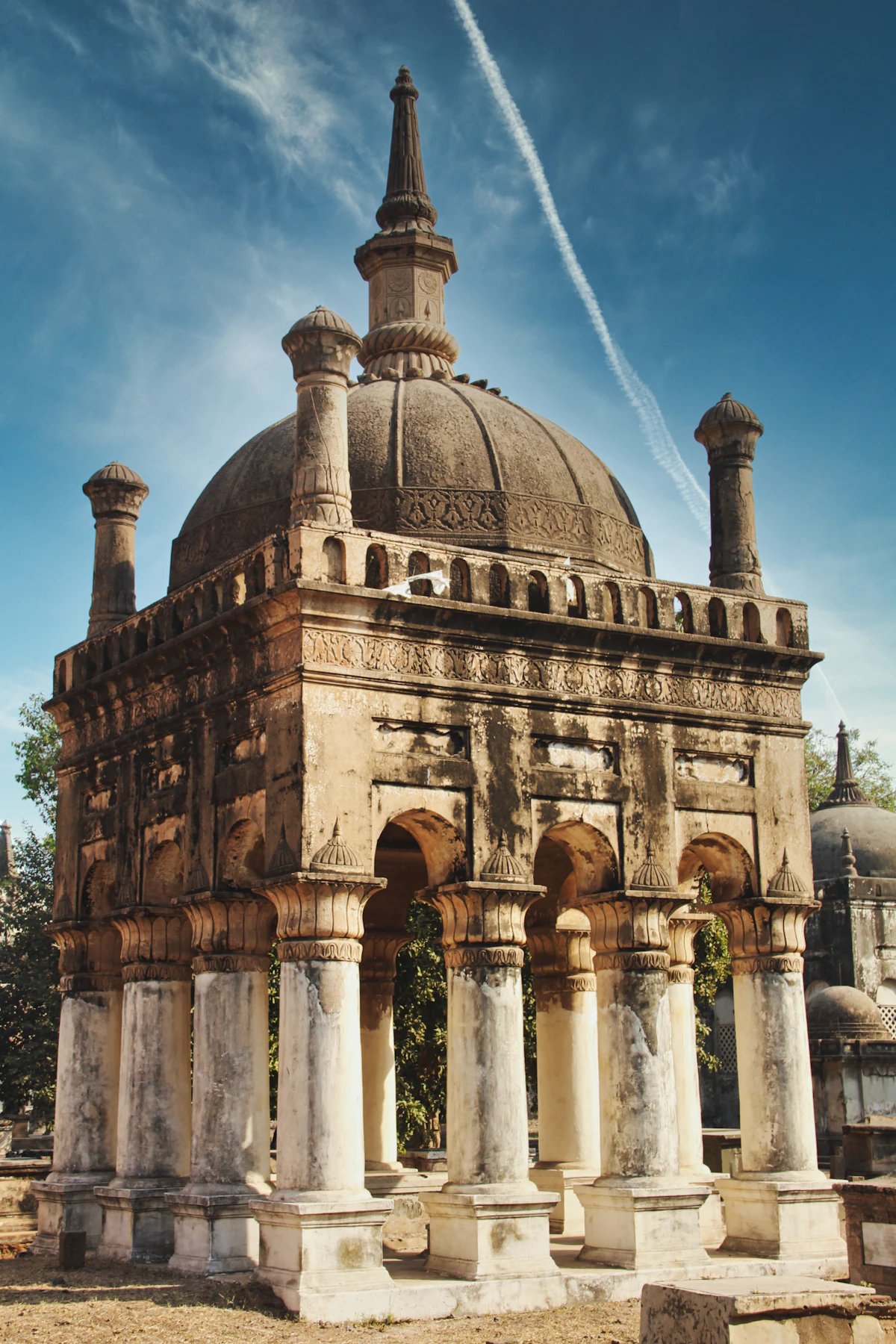 A brown brick tomb under a blue sky at the Dutch and Armenian cemetery in Surat