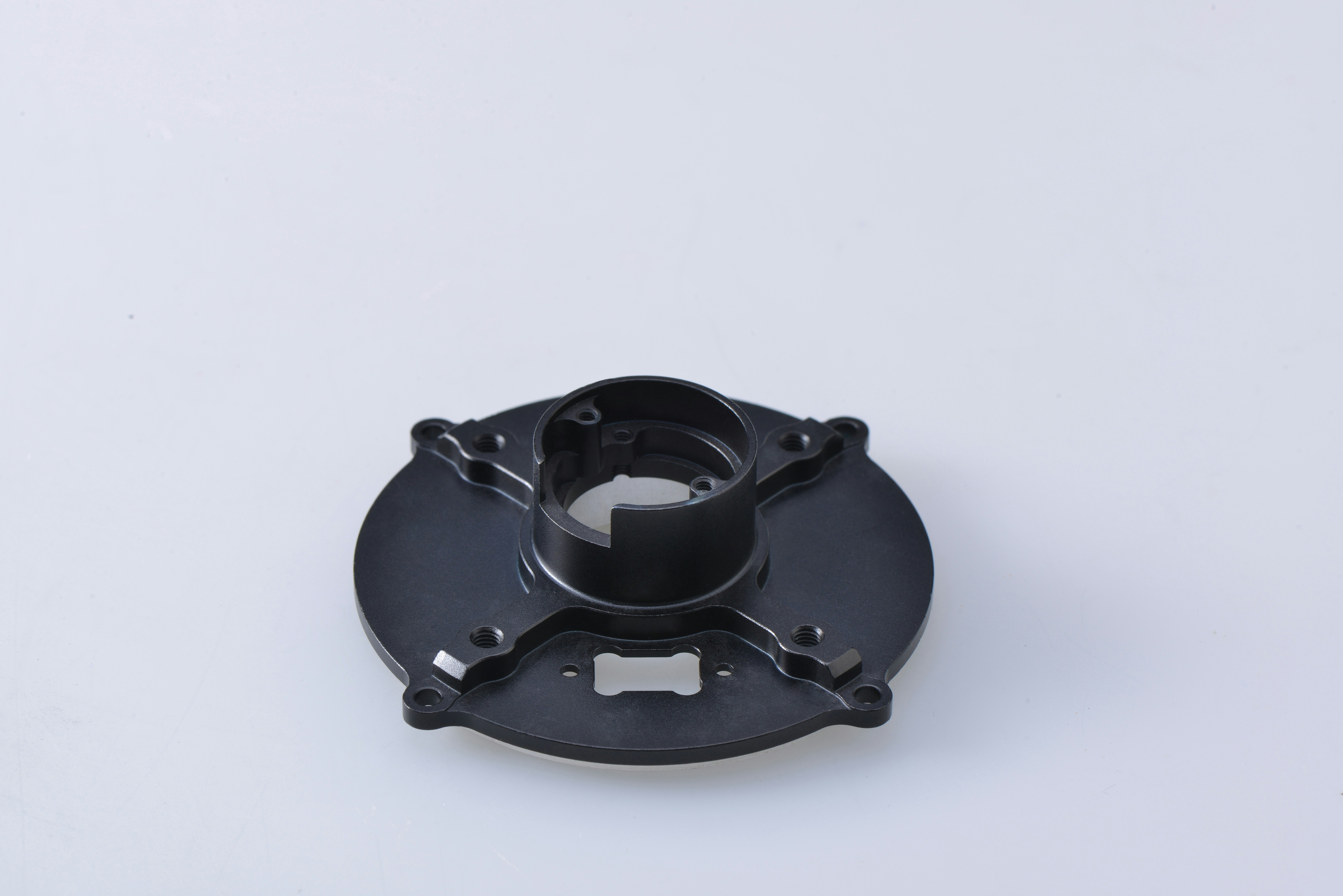 black round metal tool on white surface