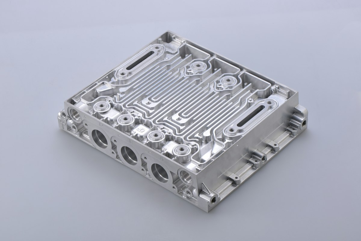 Machined aluminum block with milled pockets, bored holes and tapped features, ready for anodizing