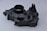 A black plastic automotive component with a circular opening, angular designs, and multiple mounting points.