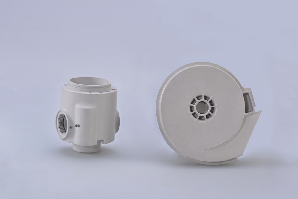 white round portable speaker on white surface