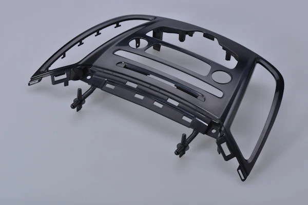 Molded automotive trim bezel