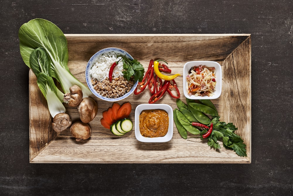 vegetable salad on brown wooden tray