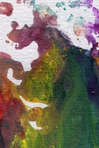 An abstract watercolor painting with a mix of vibrant colors spread across the canvas, creating a fluid and dynamic composition. The colors blend seamlessly into each other, forming intricate patterns and textures.