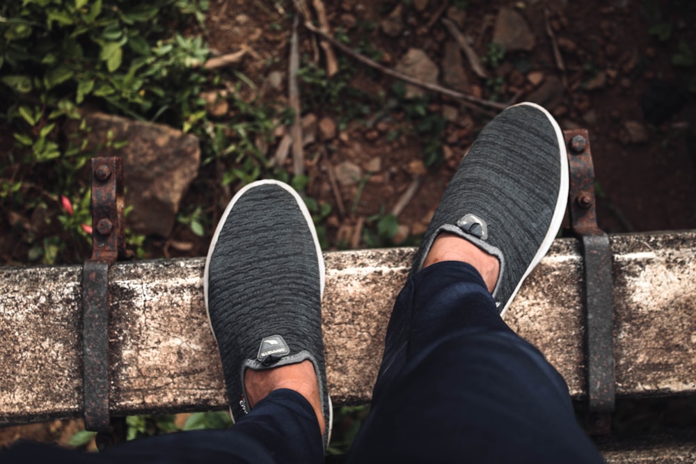 person wearing black and white sneakers