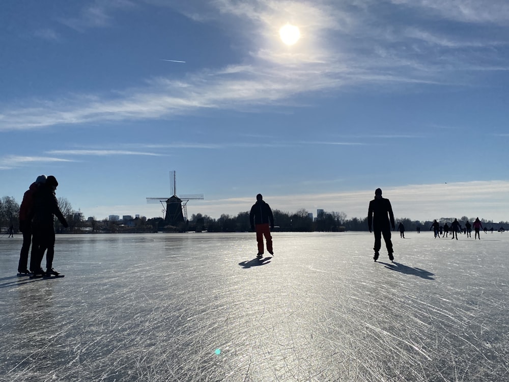 2 person standing on snow covered ground during daytime