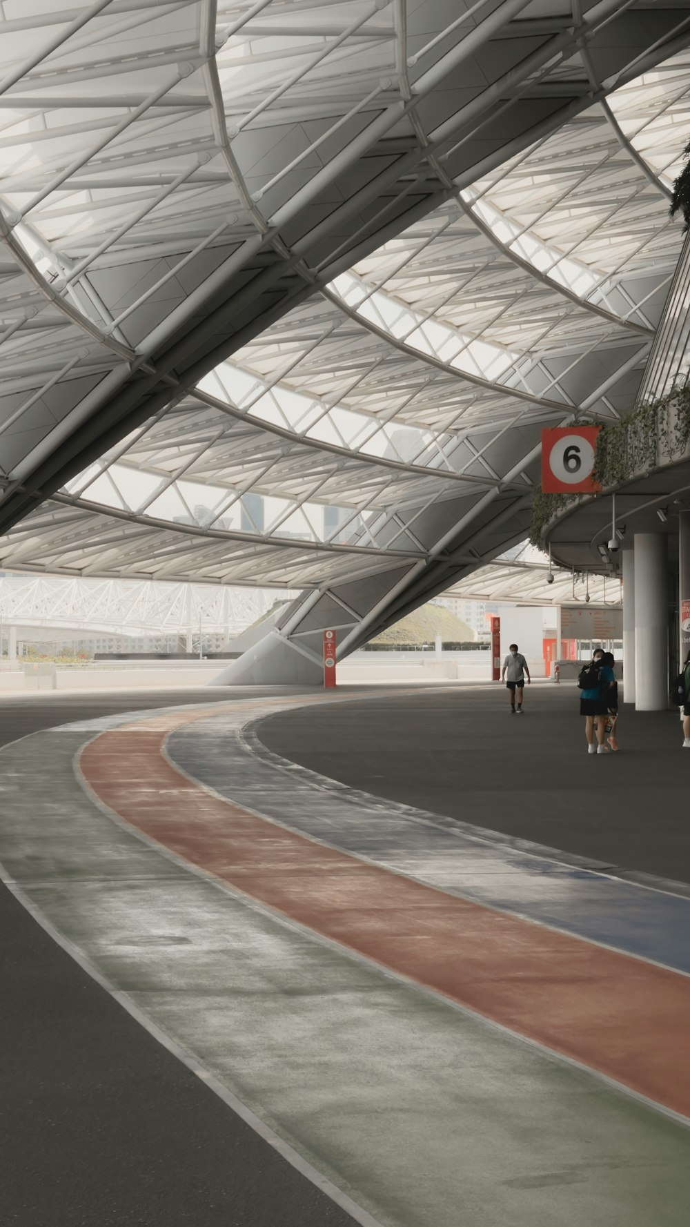 people walking on red and white track field