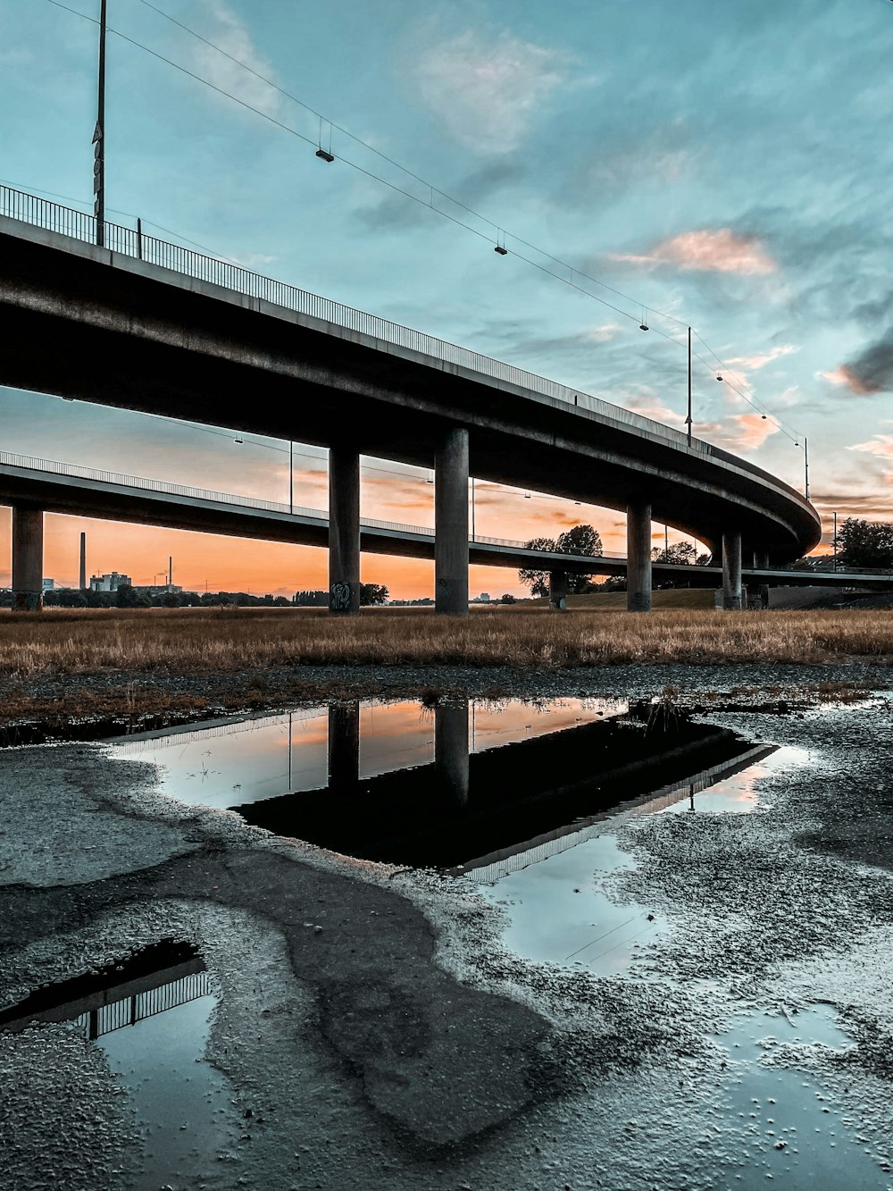 brown wooden bridge over river under white sky during daytime